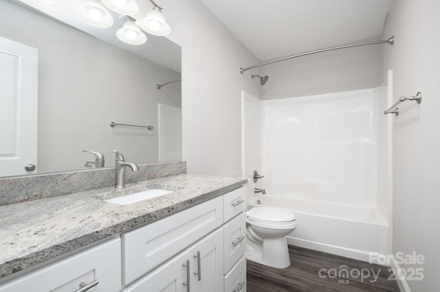 full bathroom with shower / bathing tub combination, vanity, toilet, and hardwood / wood-style flooring