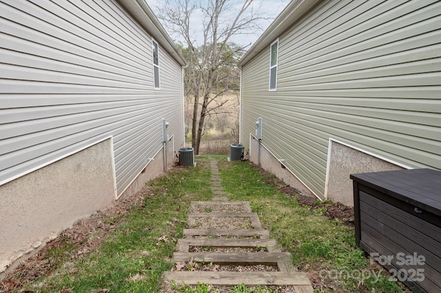 view of side of home with central AC unit