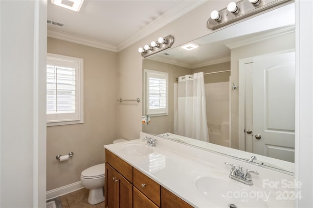 bathroom featuring a wealth of natural light, tile patterned flooring, vanity, and ornamental molding