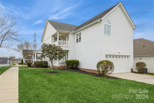 view of property exterior with a garage, a balcony, and a yard