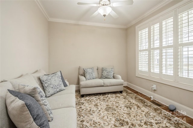 living room featuring hardwood / wood-style flooring, ceiling fan, and crown molding