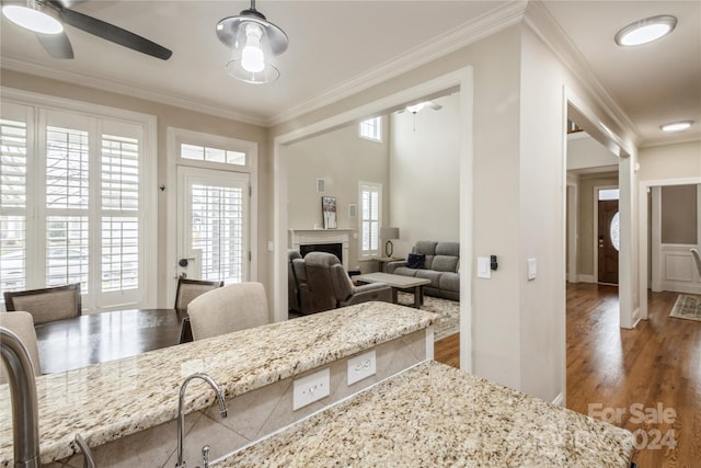 dining space with ceiling fan, hardwood / wood-style flooring, and ornamental molding