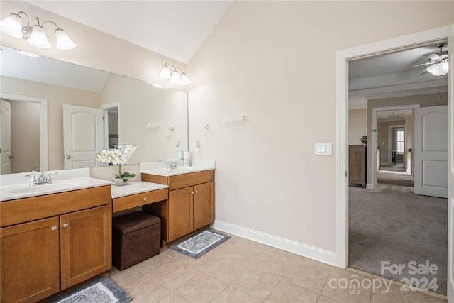 bathroom with tile patterned flooring, vanity, vaulted ceiling, and ceiling fan