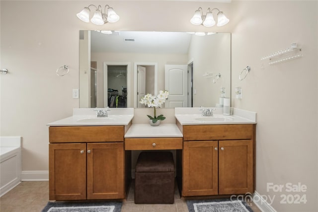 bathroom featuring tile patterned floors, a notable chandelier, and vanity