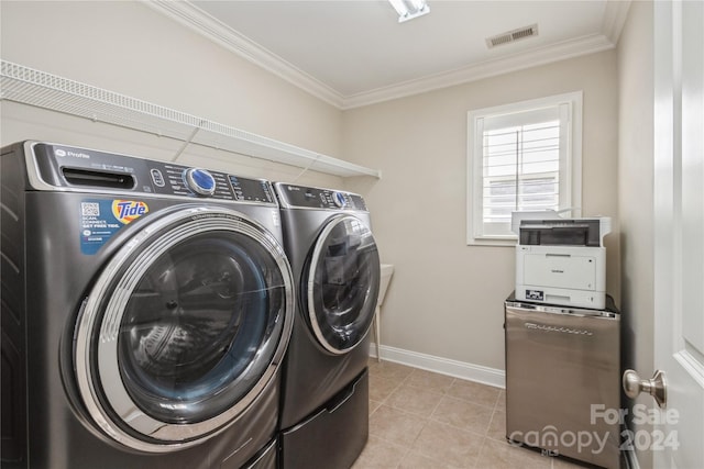 washroom featuring separate washer and dryer, ornamental molding, and light tile patterned flooring