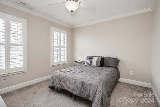 bedroom with light colored carpet, ceiling fan, and ornamental molding