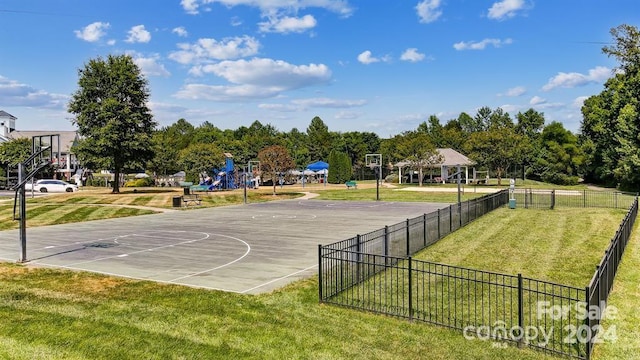 view of basketball court featuring a playground and a yard