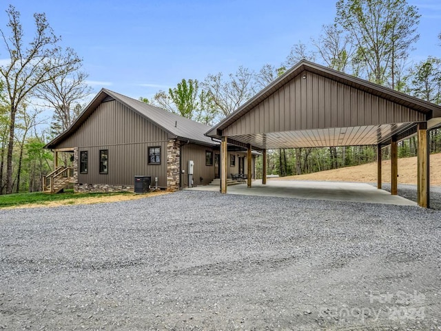 exterior space with a carport and cooling unit