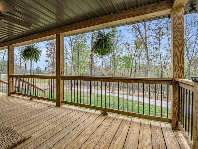 wooden deck featuring a lawn