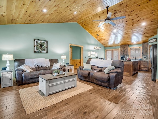 living room featuring wood ceiling, ceiling fan, sink, high vaulted ceiling, and light hardwood / wood-style floors