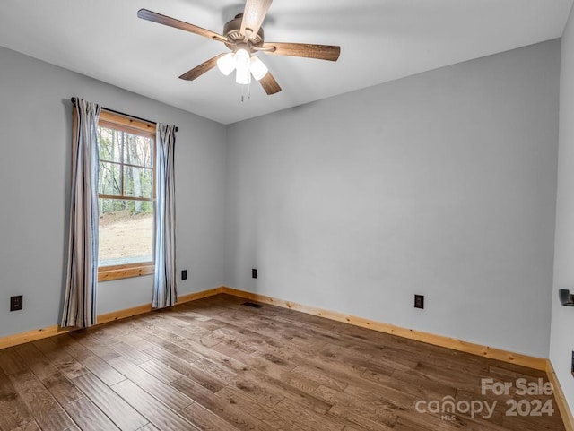 spare room featuring ceiling fan and hardwood / wood-style floors