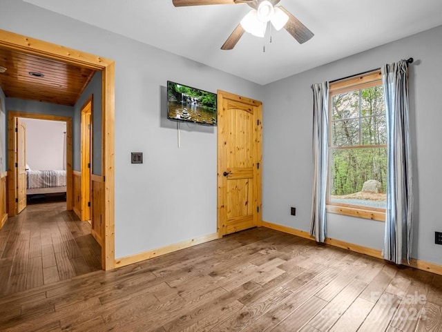 unfurnished room featuring ceiling fan and light wood-type flooring