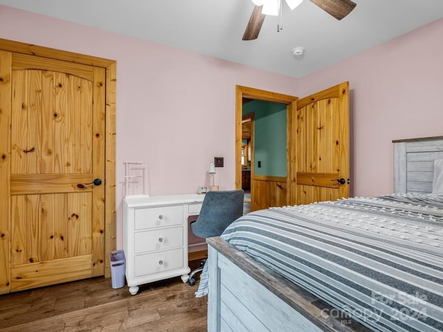 bedroom featuring ceiling fan and dark wood-type flooring