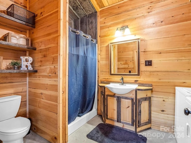 bathroom featuring a shower with shower curtain, vanity, toilet, and wooden walls