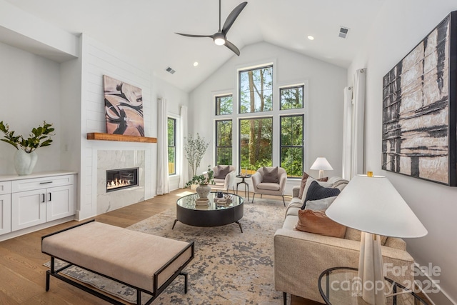 living area featuring ceiling fan, a wealth of natural light, and wood finished floors