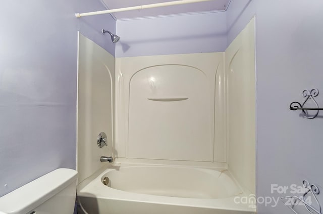 bathroom with shower / bathing tub combination and toilet