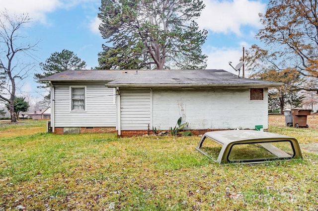 back of house with a lawn