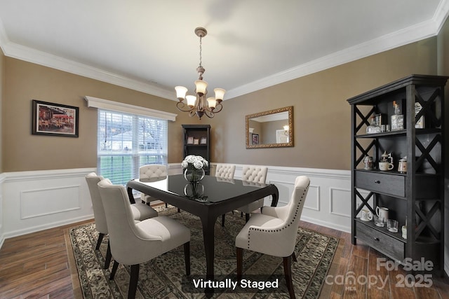 dining space featuring crown molding, dark wood-type flooring, and a chandelier