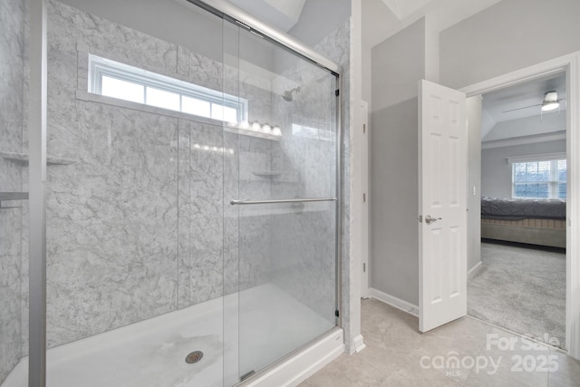 bathroom with tile patterned flooring, plenty of natural light, ceiling fan, and a shower with shower door