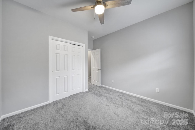 unfurnished bedroom featuring ceiling fan, carpet flooring, and a closet