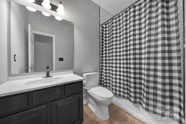 full bathroom with vanity, hardwood / wood-style floors, shower / tub combo with curtain, and toilet