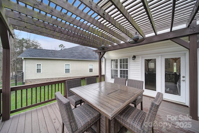 wooden terrace featuring a pergola and a lawn