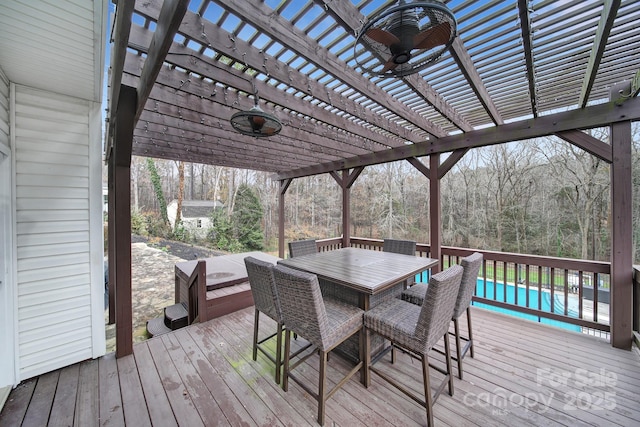 wooden deck featuring ceiling fan and a pergola