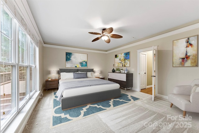 bedroom featuring ceiling fan, baseboards, and crown molding