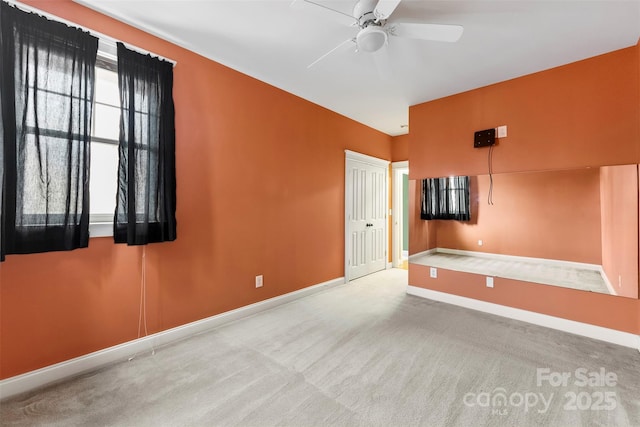 interior space with ceiling fan and baseboards