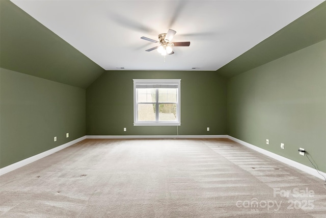 additional living space featuring carpet floors, baseboards, and vaulted ceiling