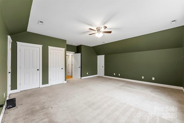 bonus room with visible vents, vaulted ceiling, and light carpet