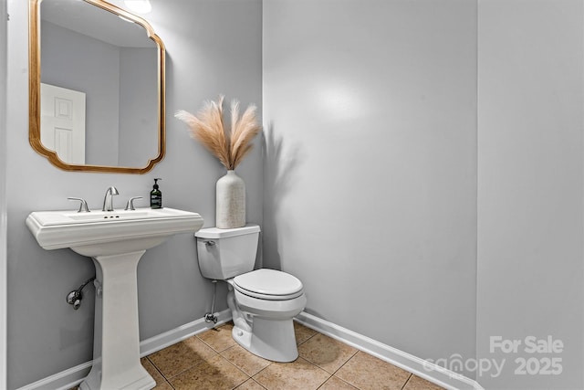 bathroom featuring toilet and tile patterned floors