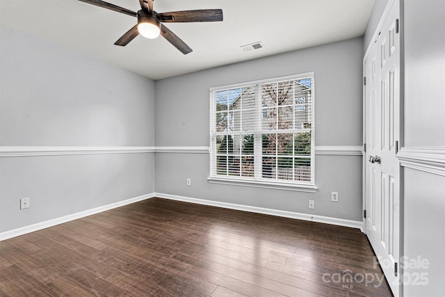 spare room with ceiling fan and dark hardwood / wood-style floors