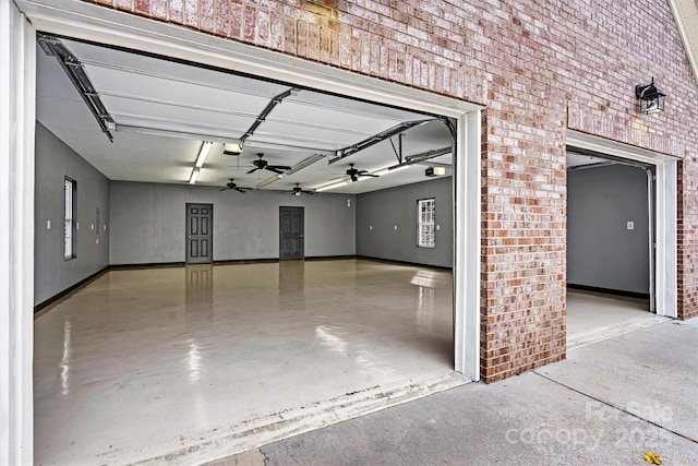 garage with a garage door opener and ceiling fan