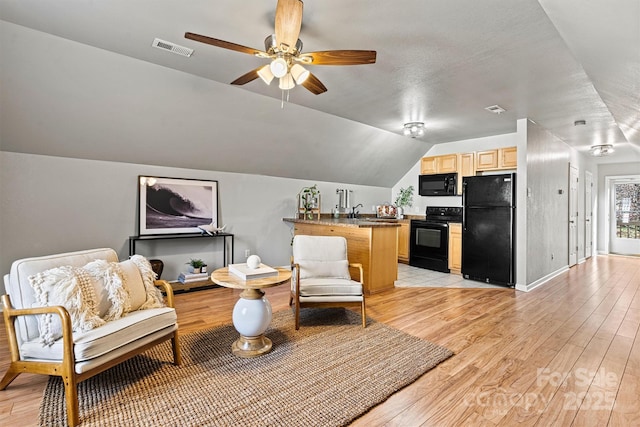 sitting room with ceiling fan, lofted ceiling, light hardwood / wood-style flooring, and sink