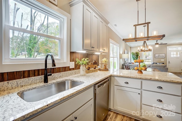 kitchen with dishwasher, decorative light fixtures, white cabinets, and sink