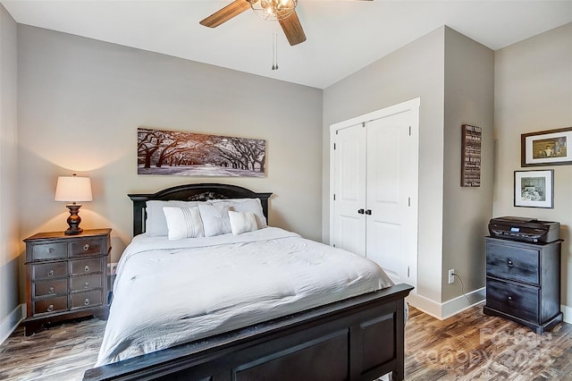 bedroom featuring dark hardwood / wood-style floors, a closet, and ceiling fan