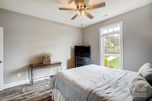 bedroom with ceiling fan and dark wood-type flooring