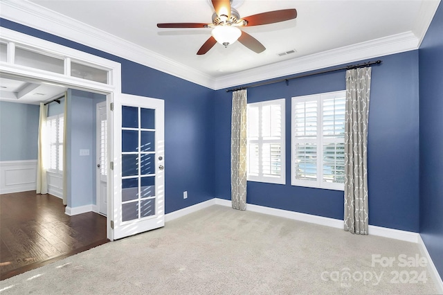 empty room with ceiling fan, wood-type flooring, and ornamental molding