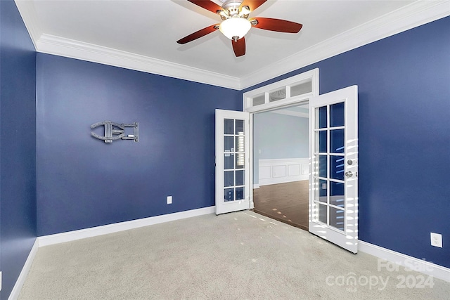 empty room with crown molding, french doors, carpet floors, and ceiling fan