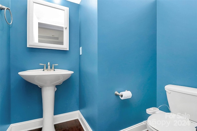 bathroom featuring hardwood / wood-style flooring and toilet