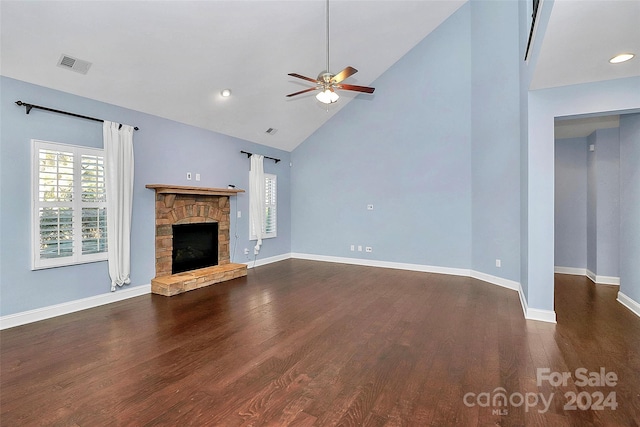 unfurnished living room featuring dark hardwood / wood-style floors, ceiling fan, a fireplace, and high vaulted ceiling