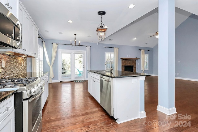 kitchen featuring an island with sink, white cabinets, and stainless steel appliances