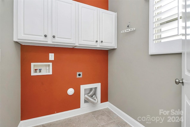 clothes washing area featuring hookup for an electric dryer, hookup for a washing machine, cabinets, gas dryer hookup, and light tile patterned flooring