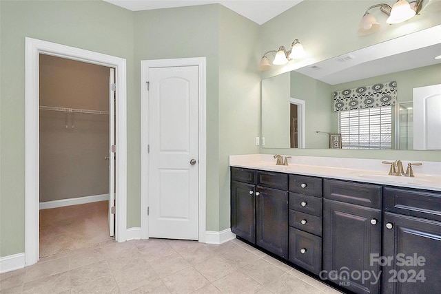 bathroom with tile patterned flooring and vanity