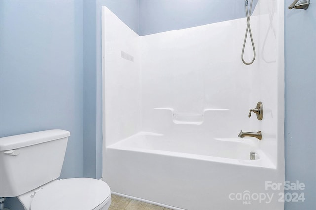 bathroom with tile patterned floors, toilet, and shower / washtub combination