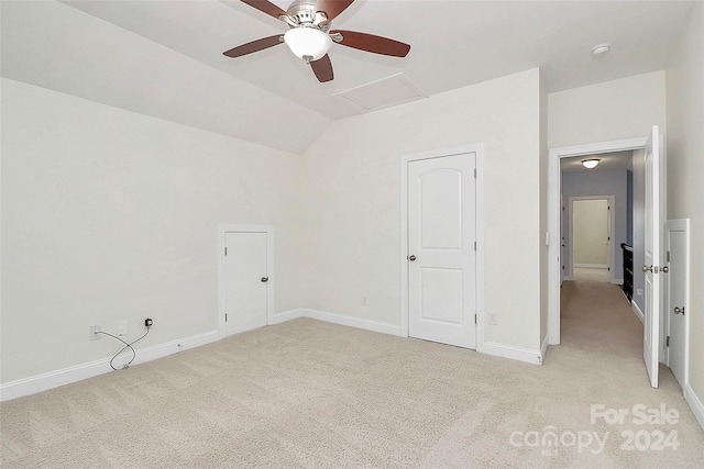 carpeted spare room with vaulted ceiling