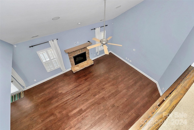 unfurnished living room with a fireplace, hardwood / wood-style flooring, ceiling fan, and lofted ceiling