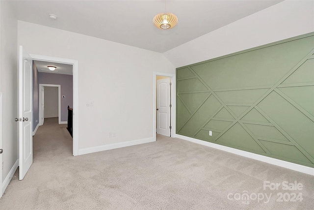 unfurnished bedroom featuring light carpet