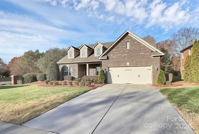 view of front of house featuring a garage and a front lawn